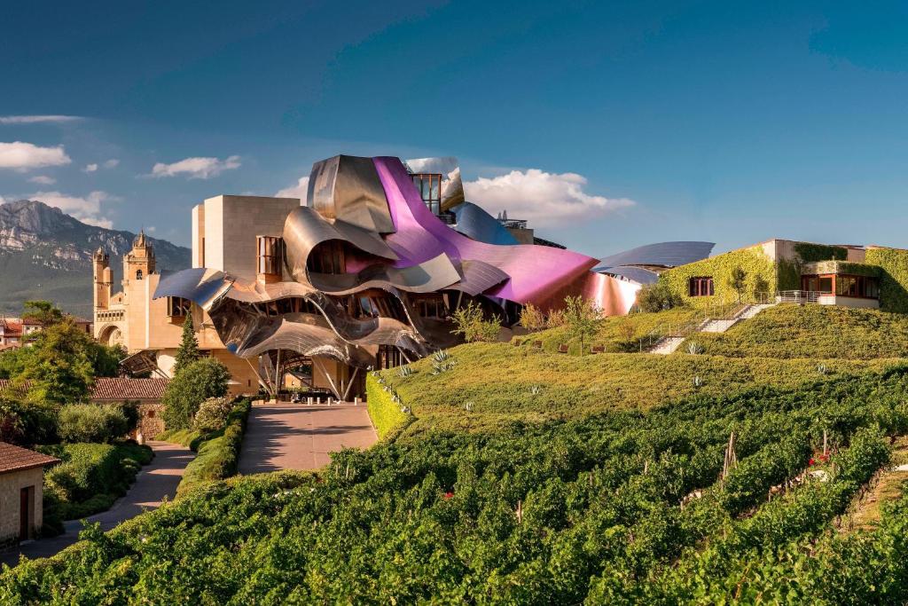 Titanium ribbons of the Gehry building above the stone winery at Elciego in Rioja