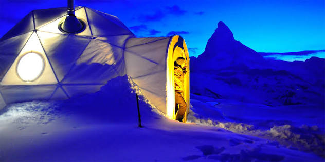 Packed snow domes of Iglu-Dorf on the slope above Zermatt with the Matterhorn beyond